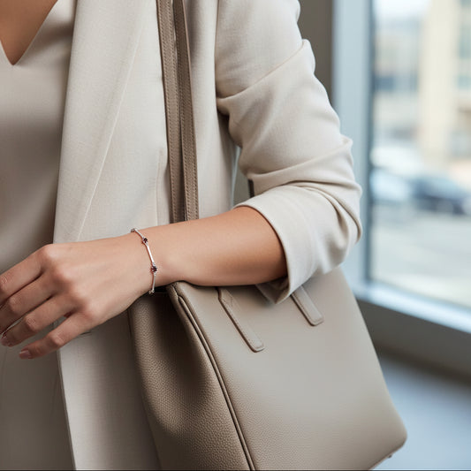 Silver bracelet with red gemstones on a white background