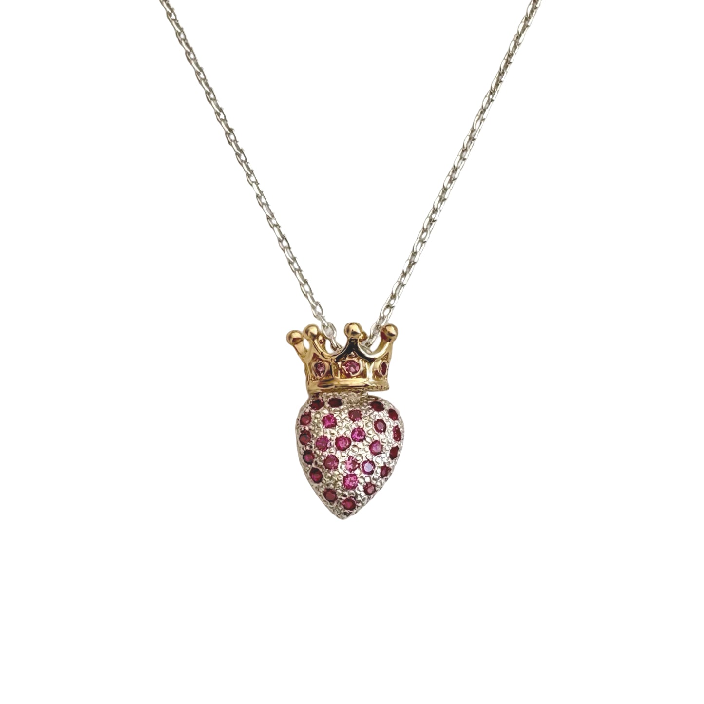 Heart-shaped pendant with a crown and embedded stones on a chain against a white background