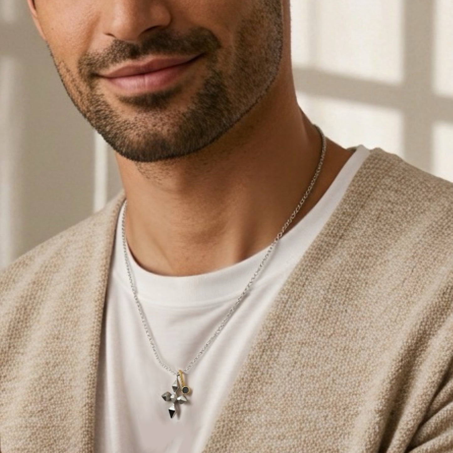 Man wearing an unusual silver necklace with a pendant, close-up of neck and chest.