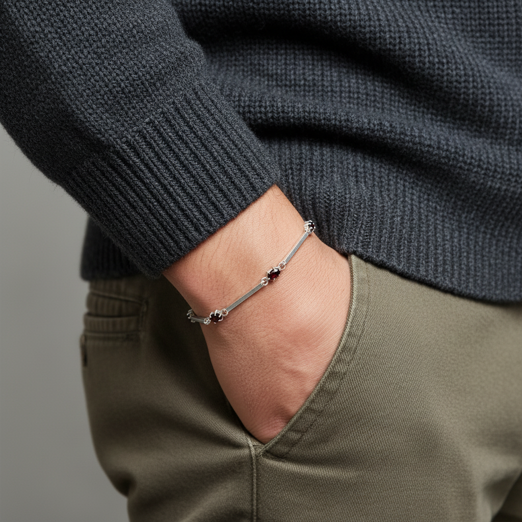 a man holding his hand in the pocket but you can see a bracelet with deep red zirconias on his wrist