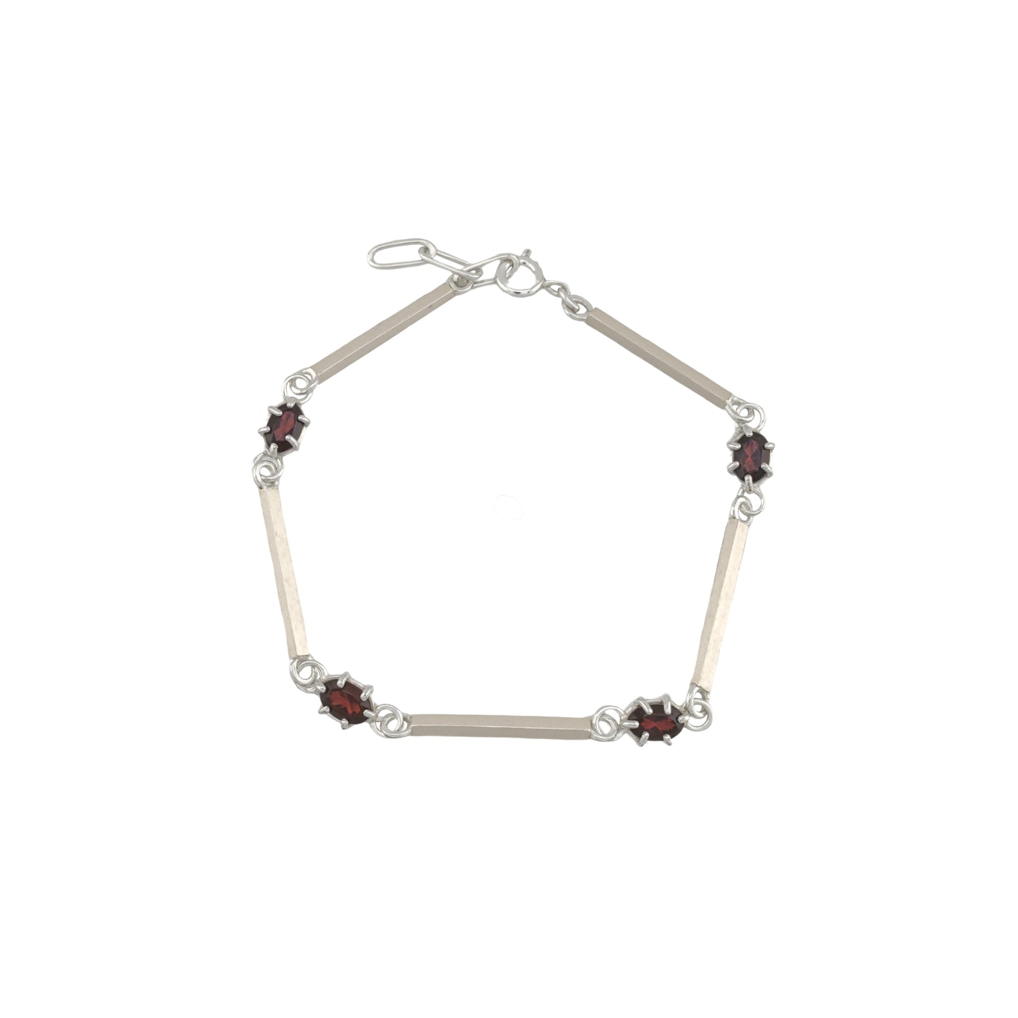Silver bracelet with red gemstones on a white background