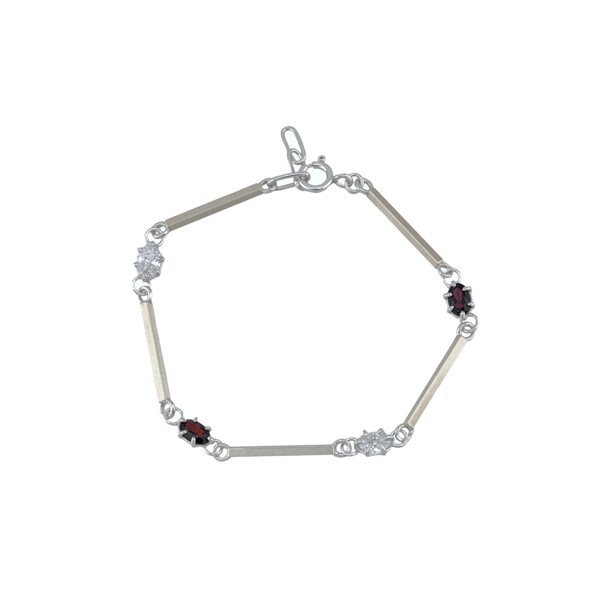 Silver bracelet with white and red gemstones on a white background