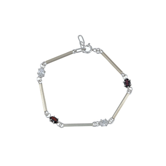 Silver bracelet with white and red gemstones on a white background