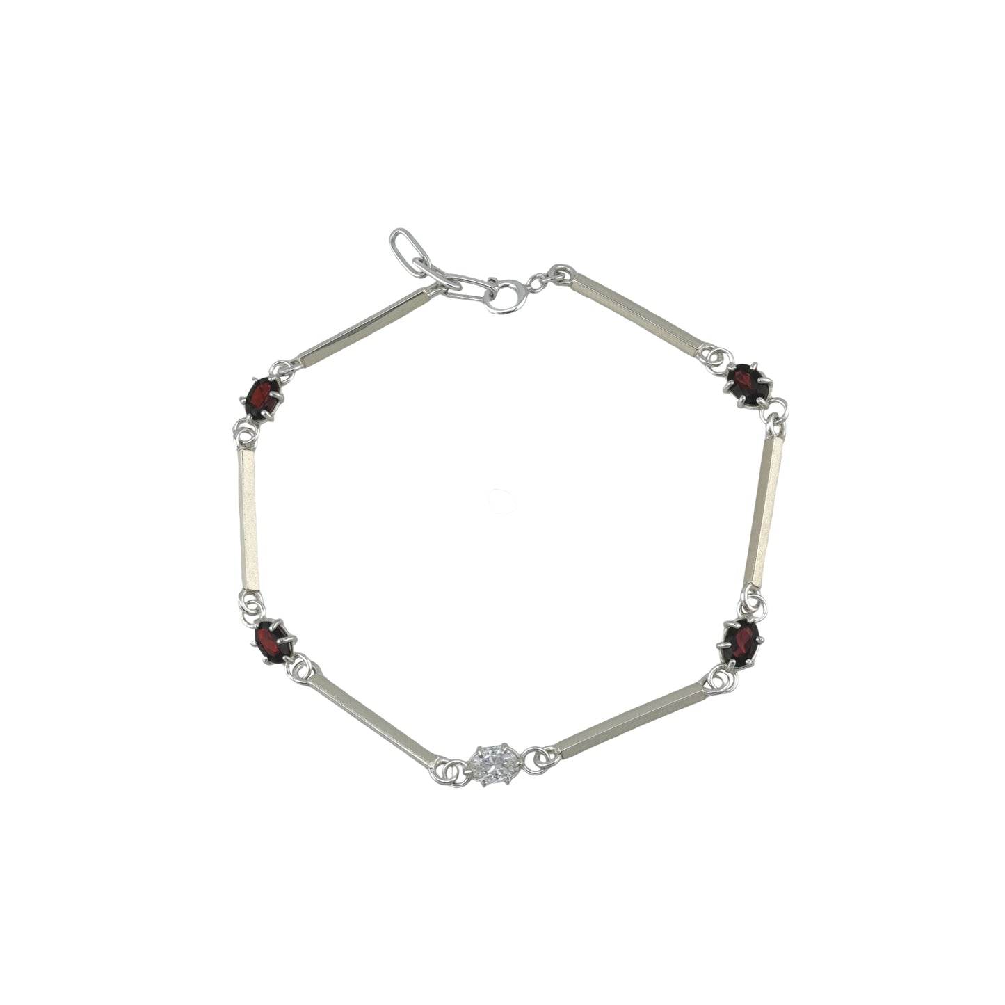 Silver bracelet with red and white gemstones on a white background