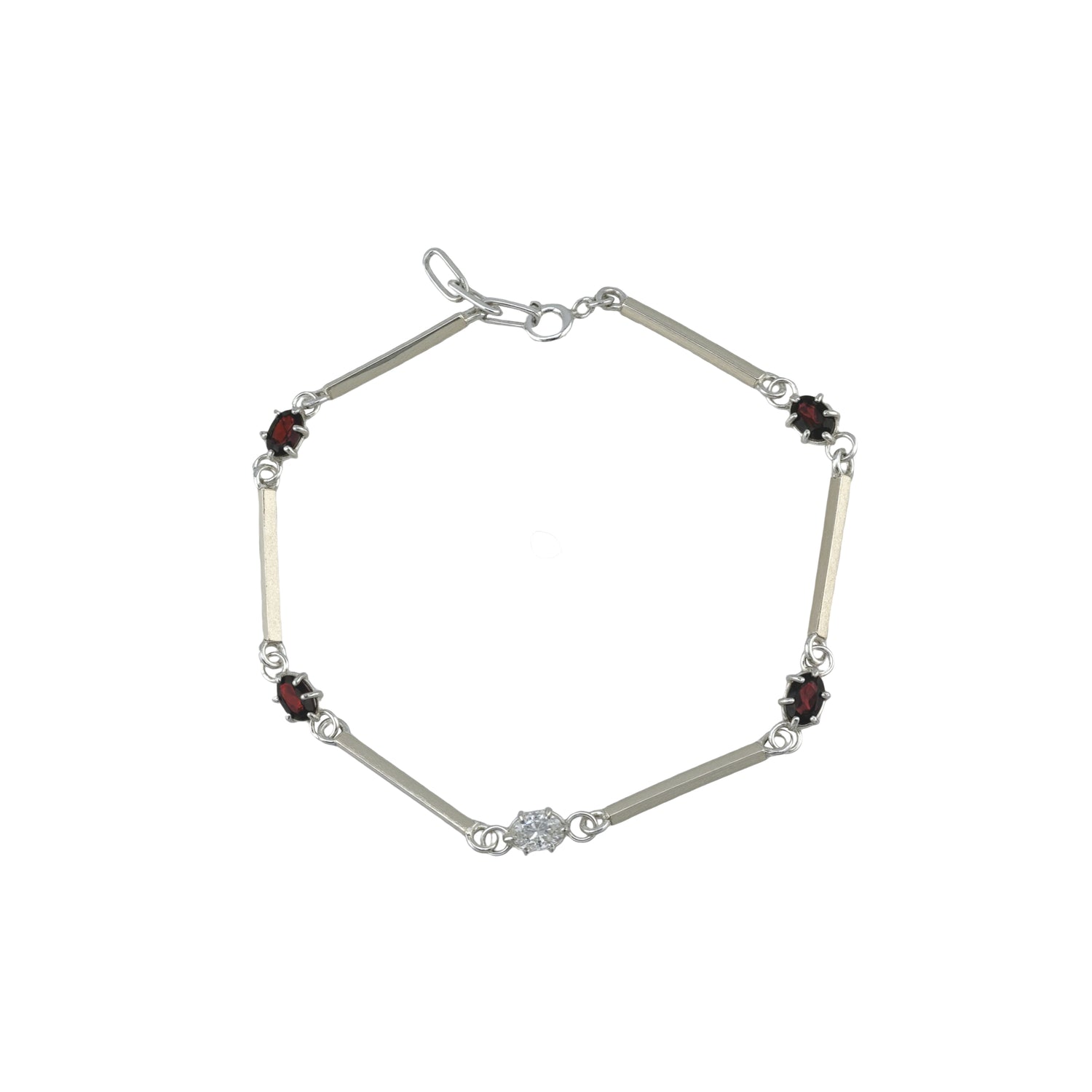 Silver bracelet with red and white gemstones on a white background