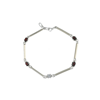 Silver bracelet with red and white gemstones on a white background