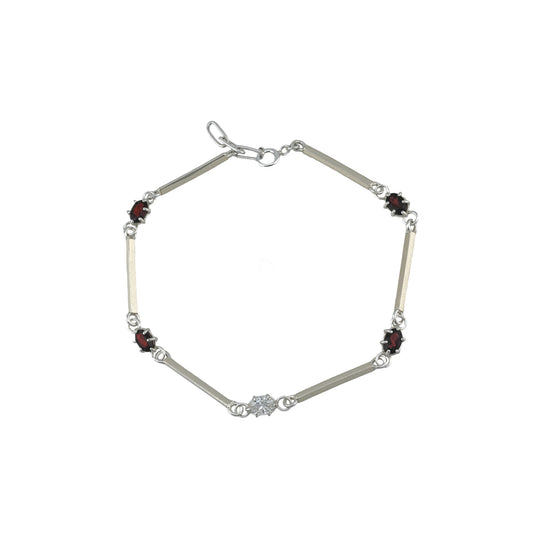 Silver bracelet with red and white gemstones on a white background