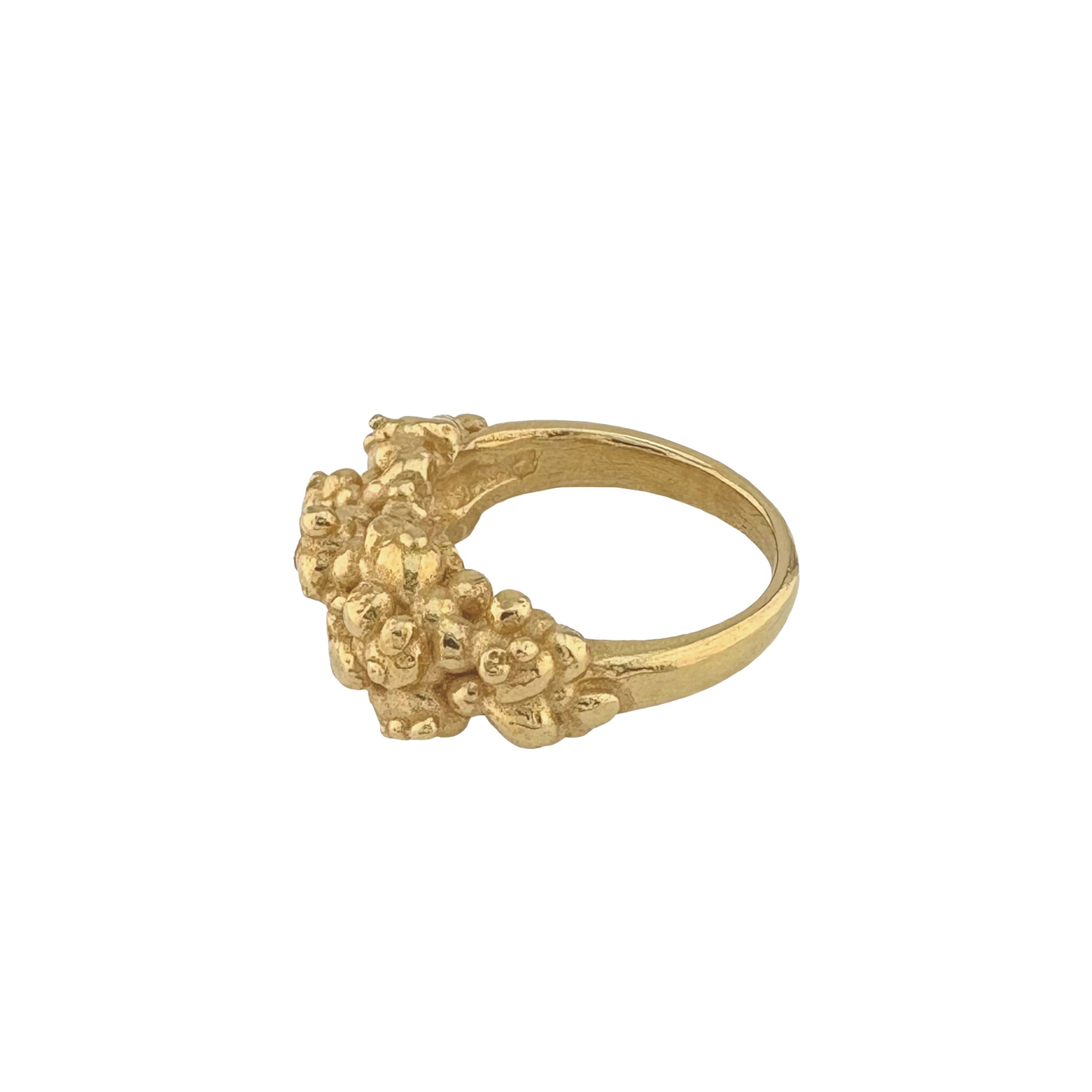 Golden ring with organic texture design on a white background side view