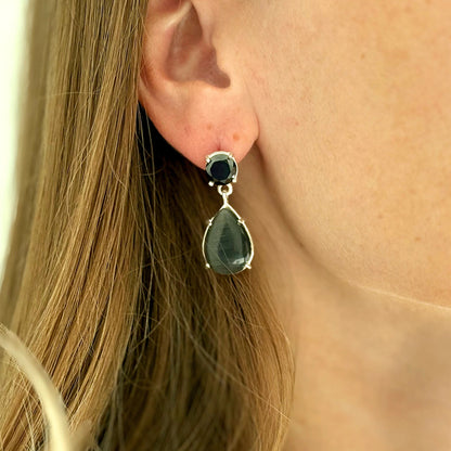female model wearing silver drop earrings with black agate and black Swarovski crystal