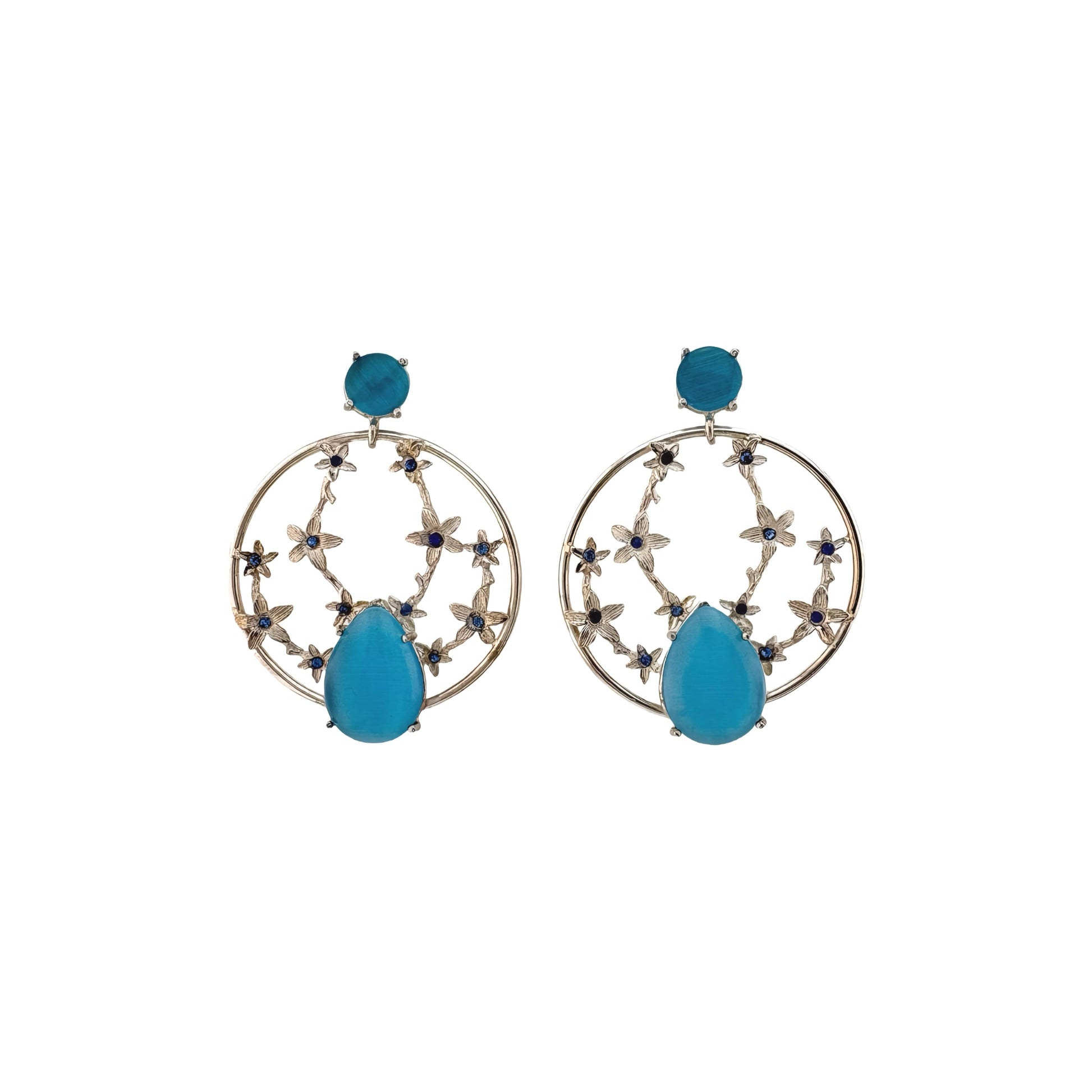 Pair of earrings with blue teardrop-shaped stones on a white background