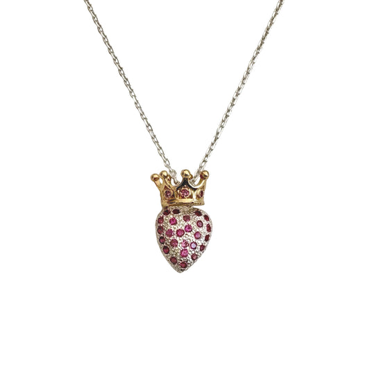 Heart-shaped pendant with a crown and embedded stones on a chain against a white background