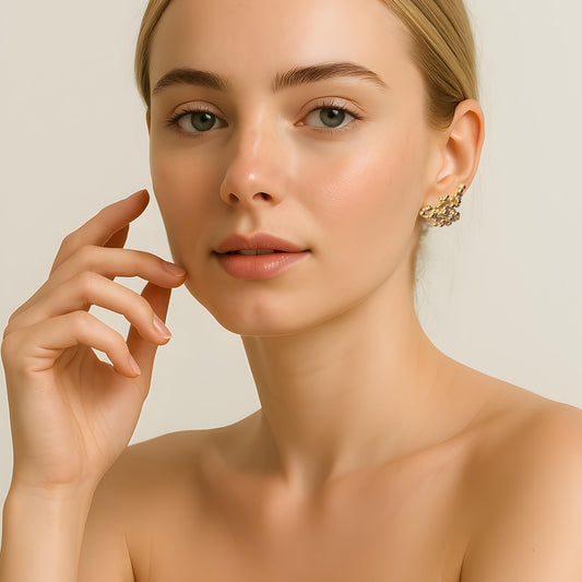 Model wearing gold plated bubble studs, organic textured style