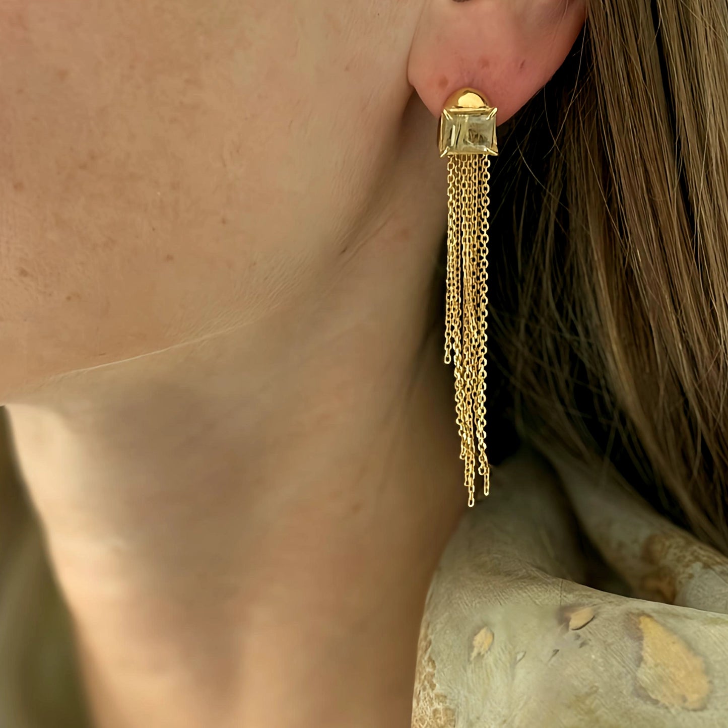 a female wearing elegant silver gold-plated earrings with cascading chain tassel