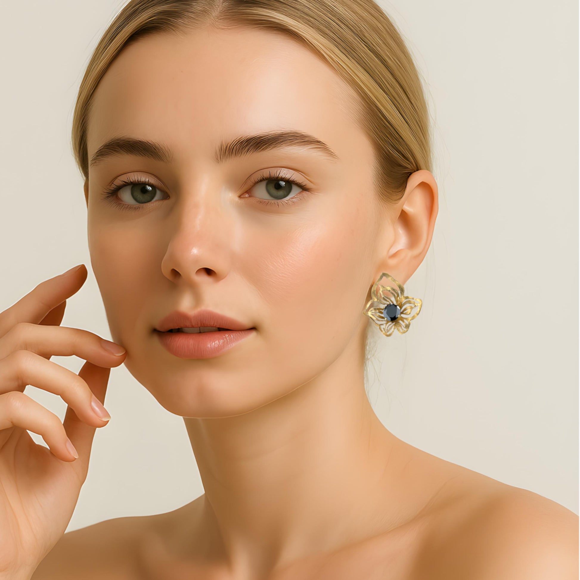Model wearing orchid stud earrings with black Swarovski crystals, floral detail