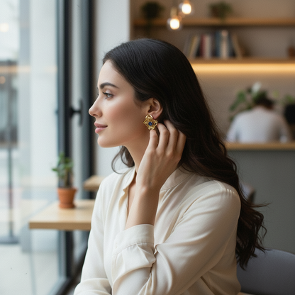 a brunete wearing golden orchid earring with blue crystal

