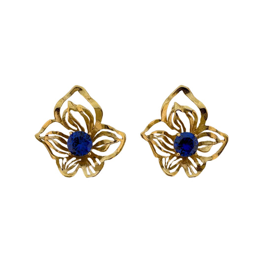 Golden orchid earrings with blue crystals on white background