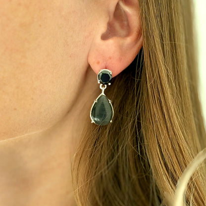 Female model wearing a silver drop earring with black Swarovski crystal and black agate