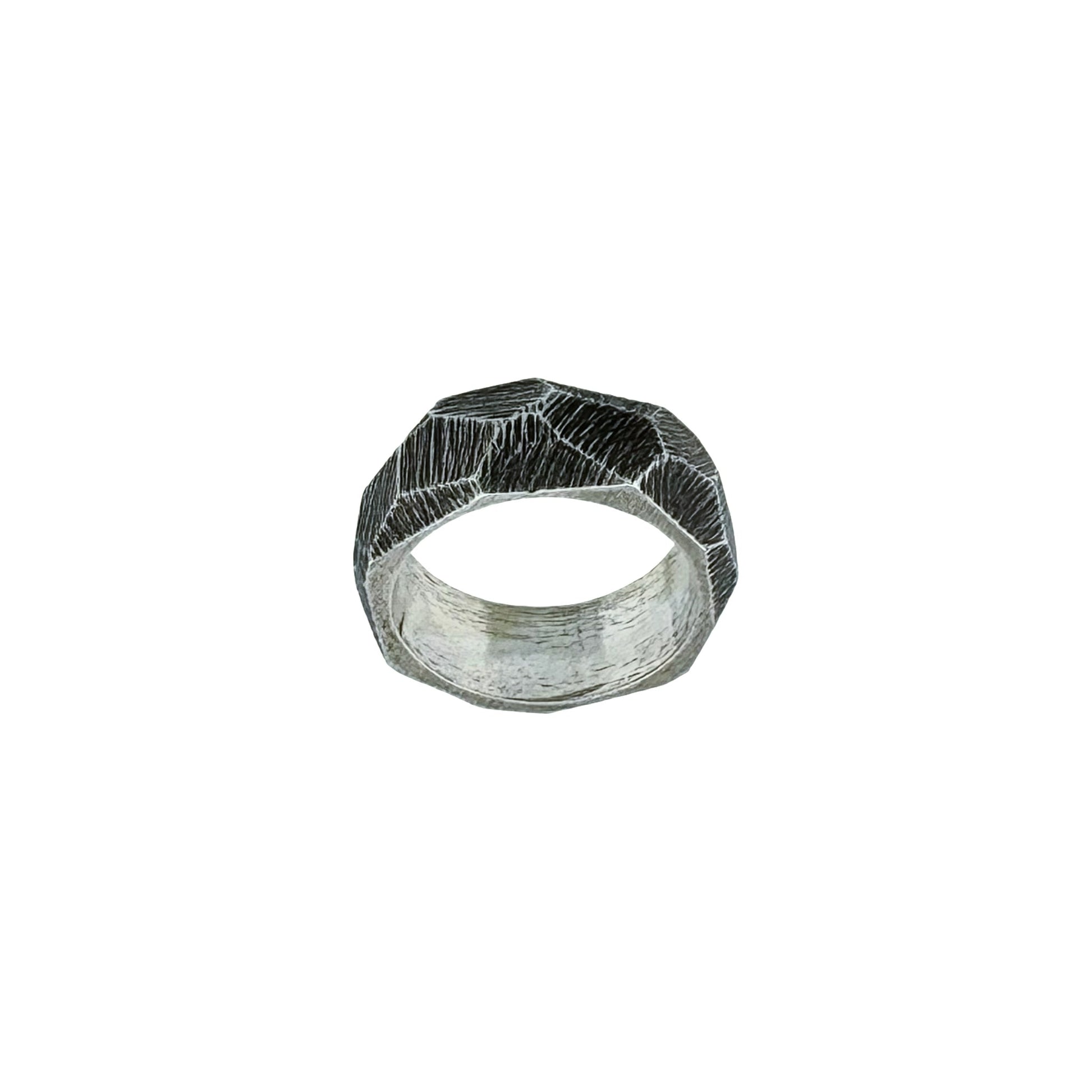 Silver ring with a textured, faceted design on a white background
