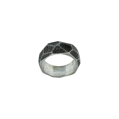 Silver ring with a textured, faceted design on a white background