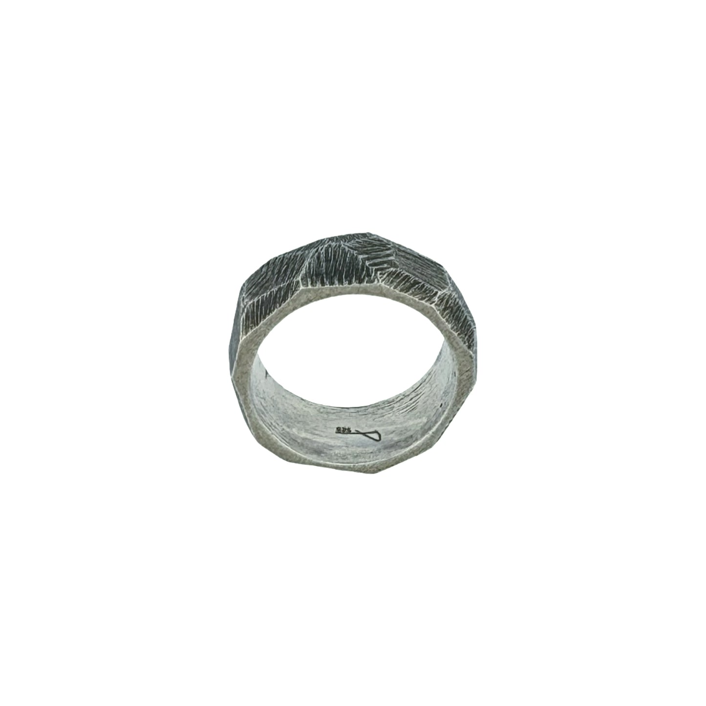 Silver ring with strong texture on white background