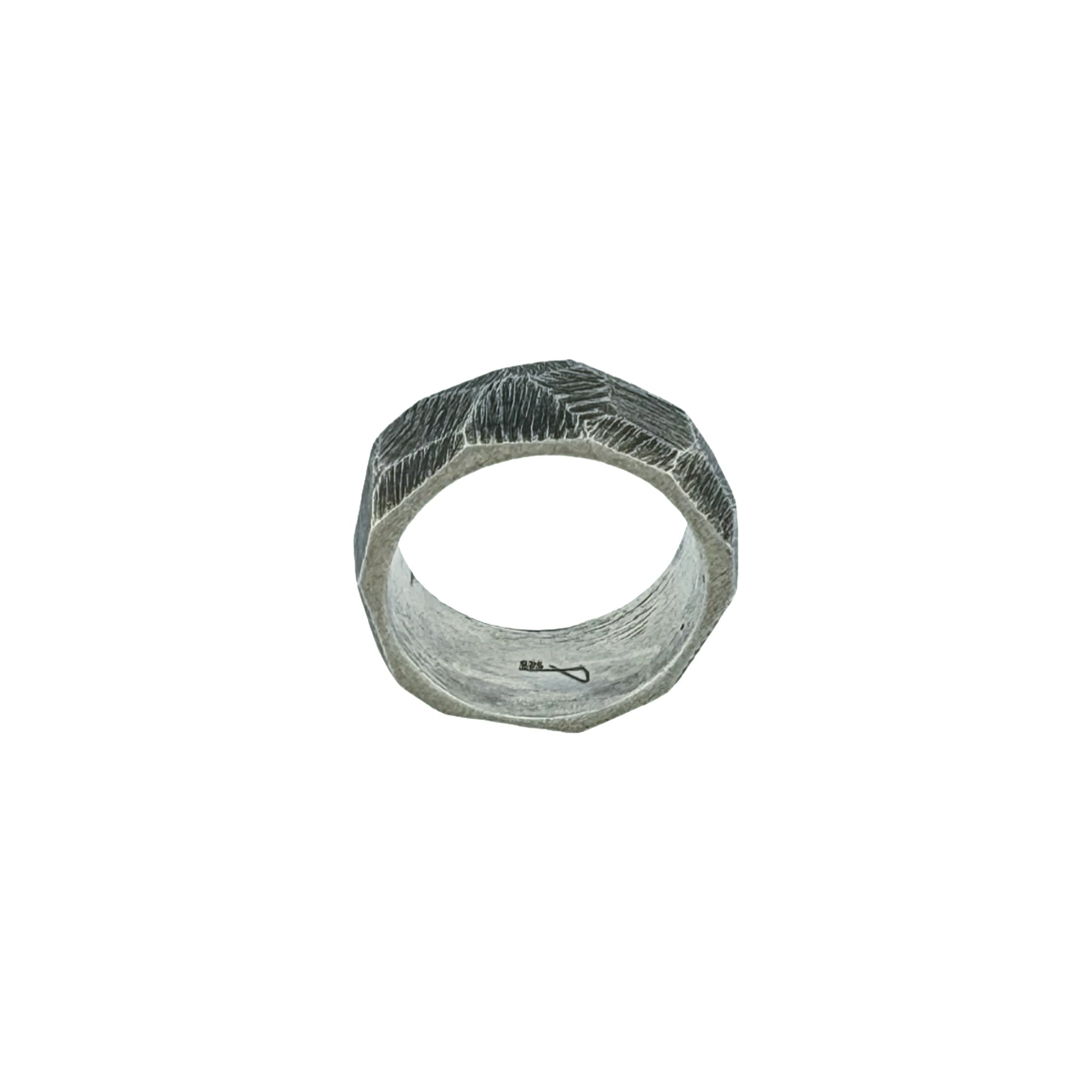 Silver ring with strong texture on white background